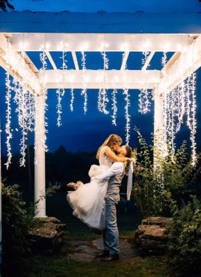 Bride and Groom kiss under pergola