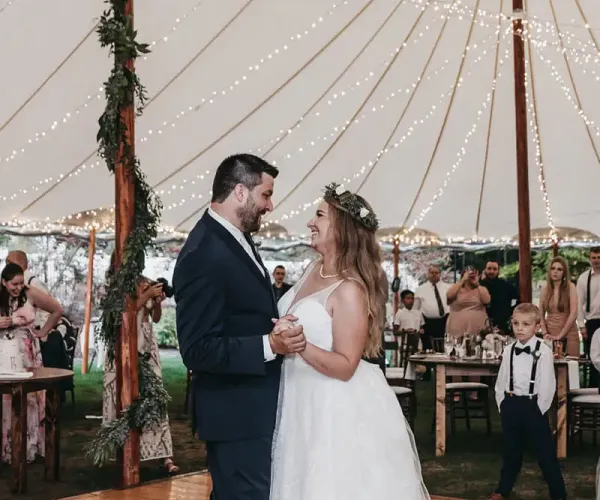 Bride and father dancing at wedding under lights