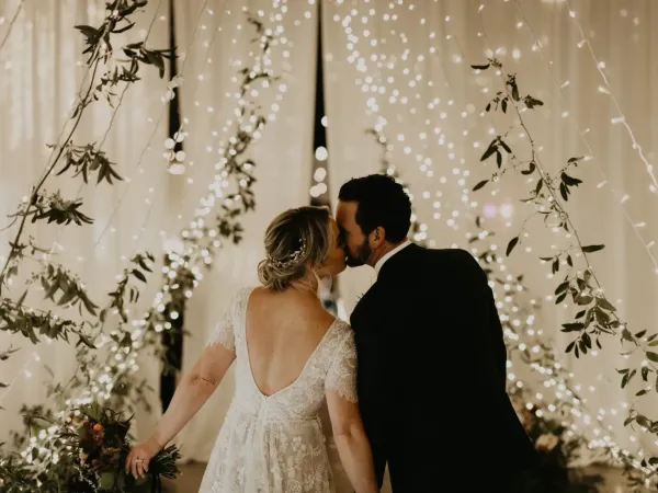 Wedding couple kissing under lights