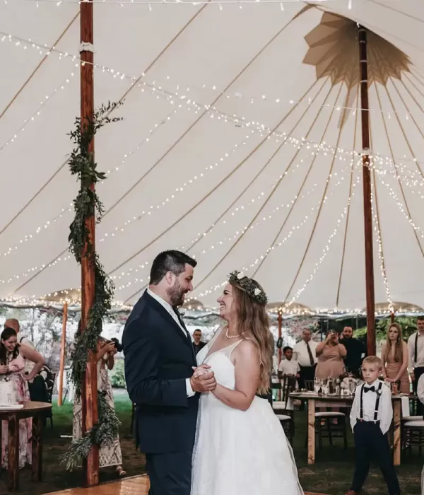 Bride and groom dancing at wedding under lights